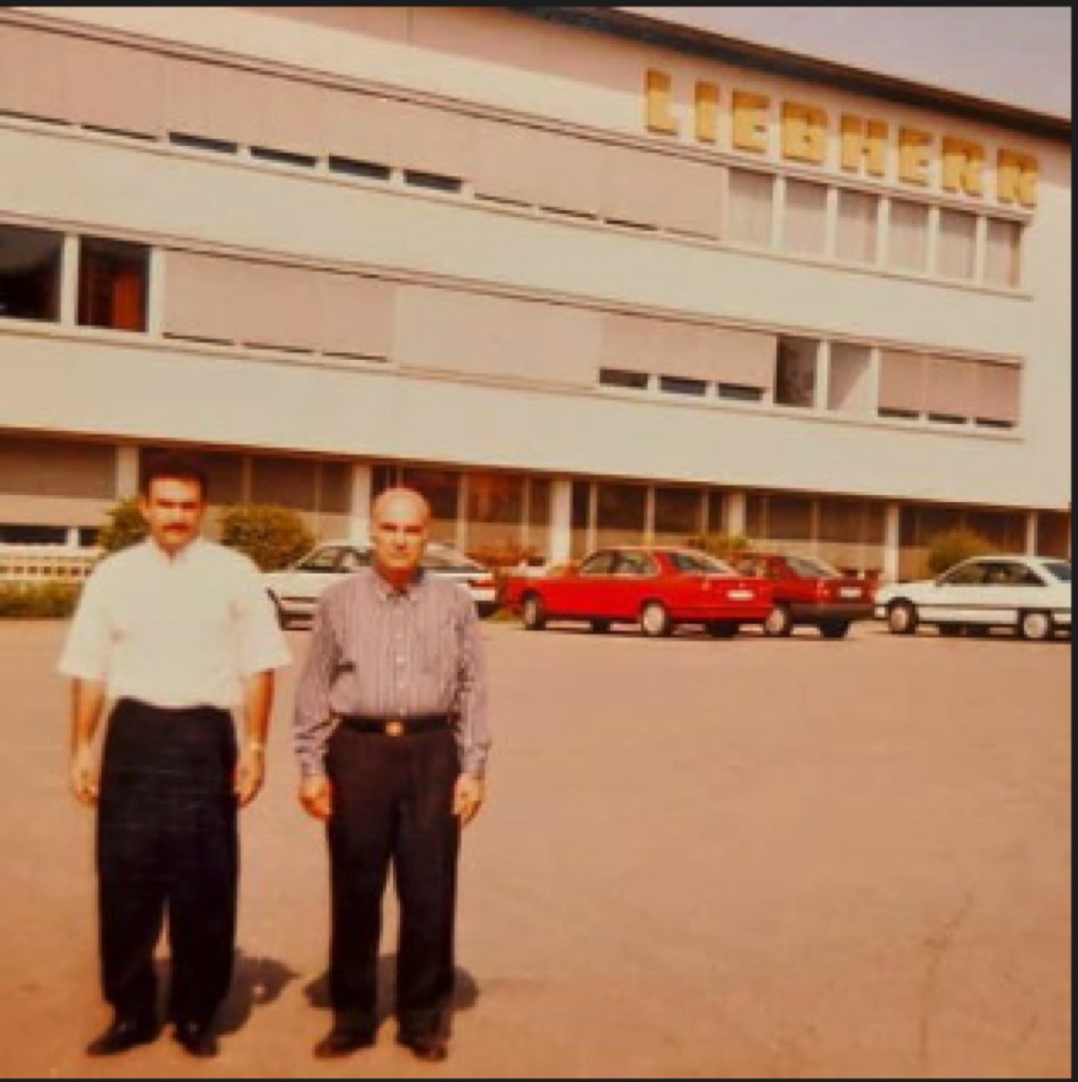 Father and son in front of a German engineering company